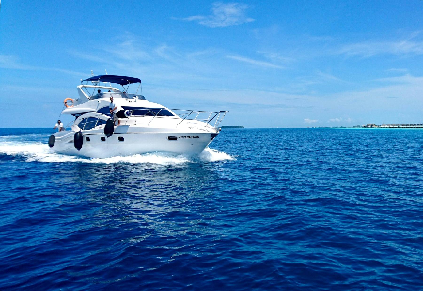 White motor yacht cruising on blue water